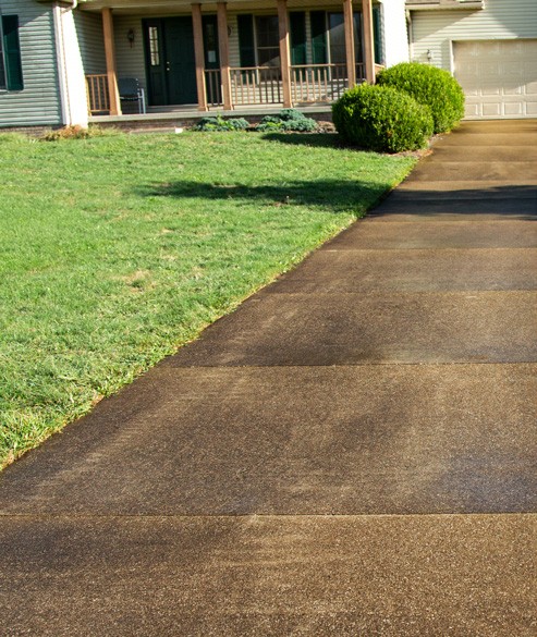 Dirty, stained driveway before pressure washing